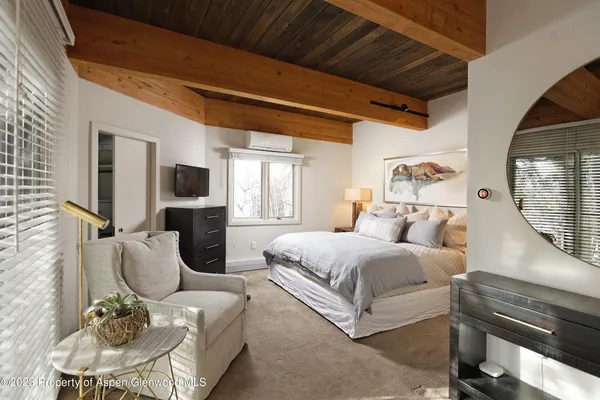 a view of a bathroom with a tub and large windows