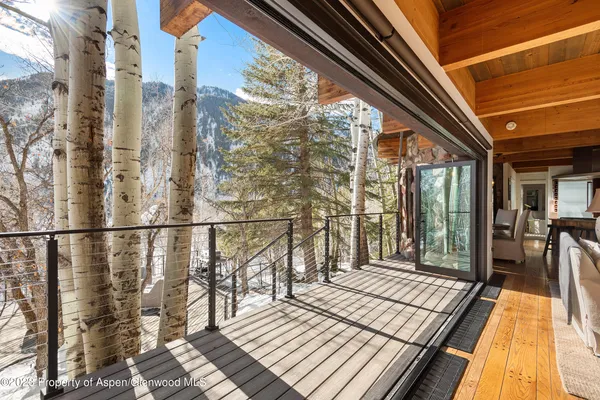 a view of a patio with couches and wooden fence