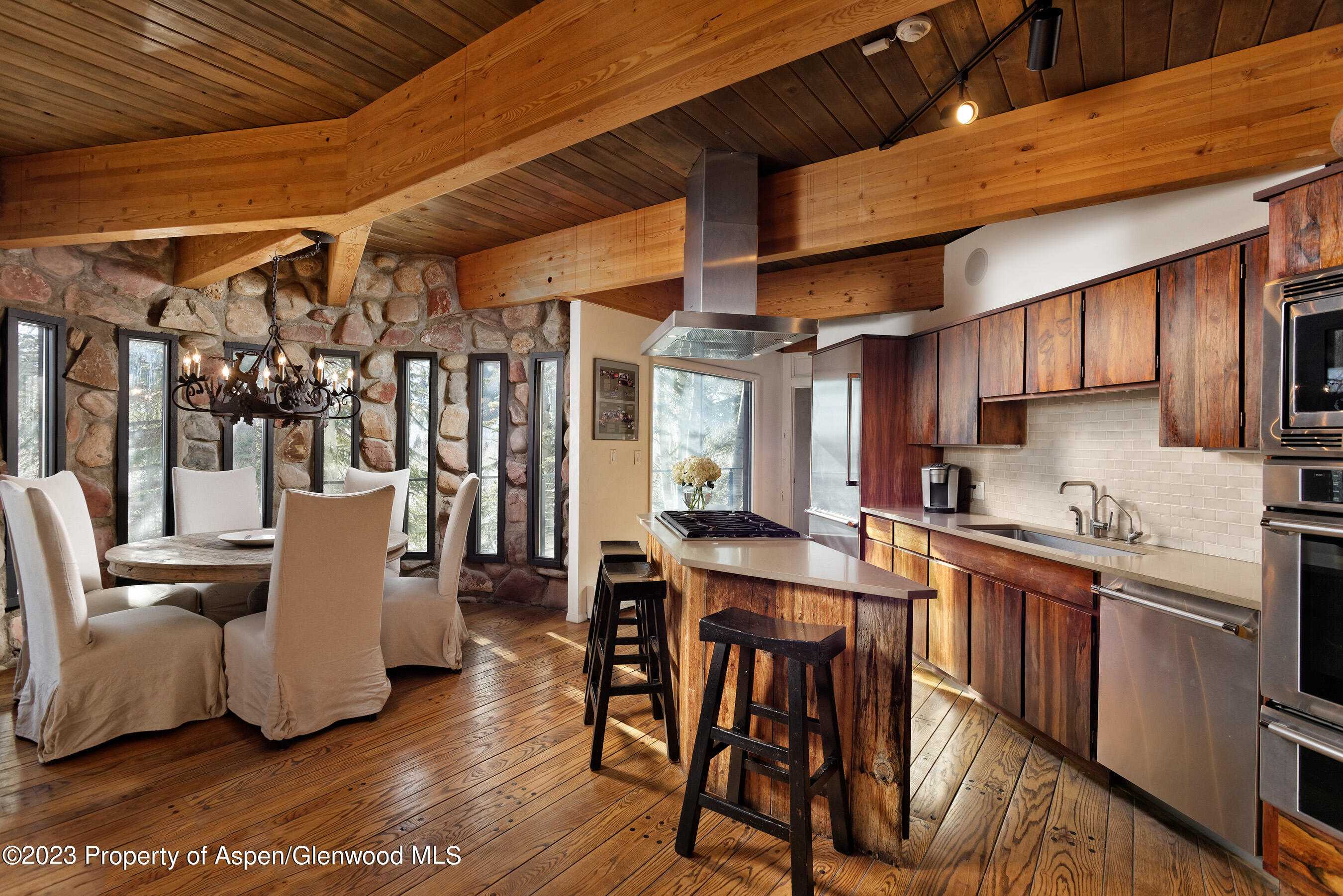 164 Eastwood Road Aspen, CO 81611 - Photo 6 of 42 a kitchen with a table chairs and wooden floor
