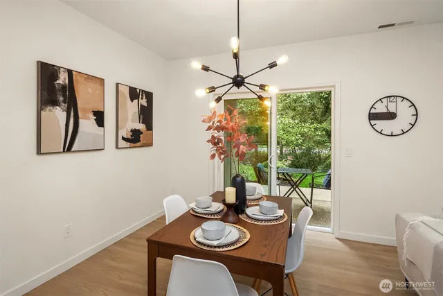 a view of a dining room with furniture window and wooden floor