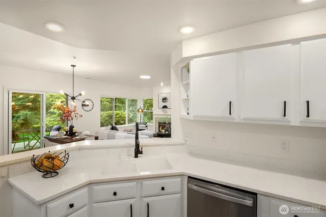 a kitchen with a sink and white cabinets