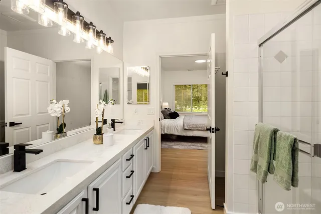 a spacious en suite bathroom with sink and mirror