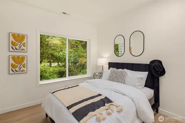 a bedroom with a bed and a window