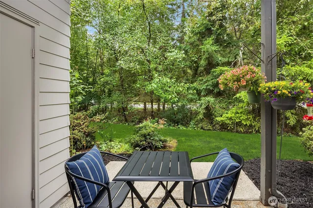 a view of backyard with seating space and trees
