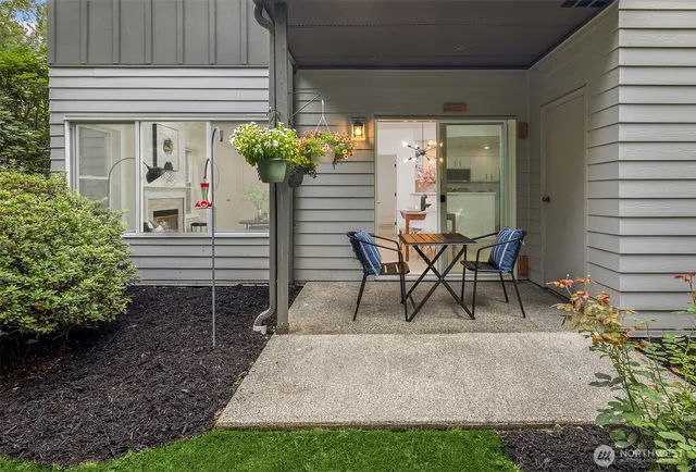 a view of a porch with chairs and a bench