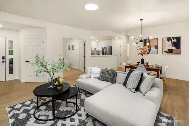 a living room with furniture and a chandelier