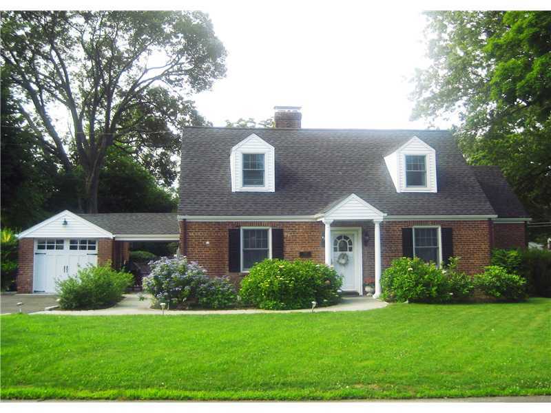 6 Northridge Road Old Greenwich, CT 06870 - Photo 1 of 14 a front view of a house with a yard and trees