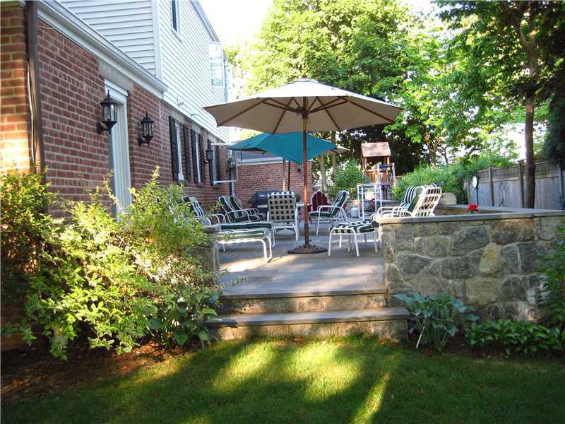 6 Northridge Road Old Greenwich, CT 06870 - Photo 13 of 14 a view of a patio with chairs and table under an umbrella