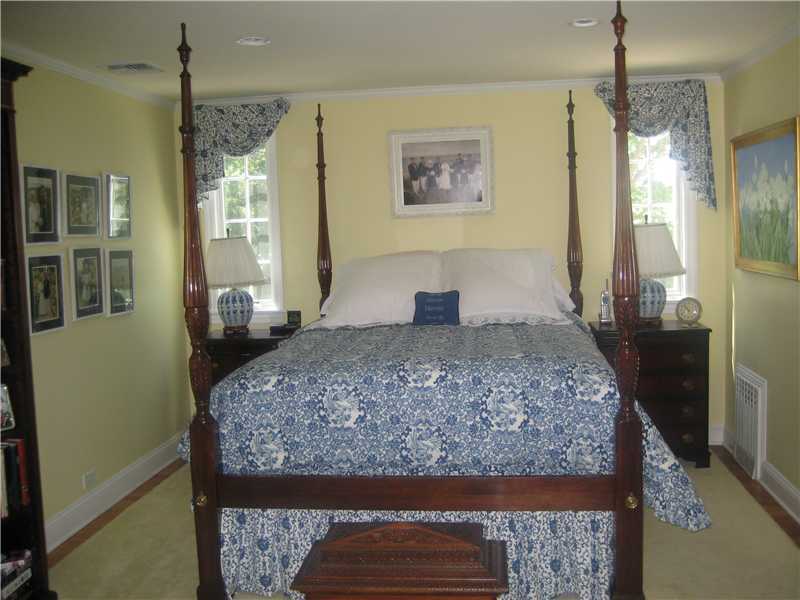 6 Northridge Road Old Greenwich, CT 06870 - Photo 7 of 14 a bedroom with a large bed and a chandelier