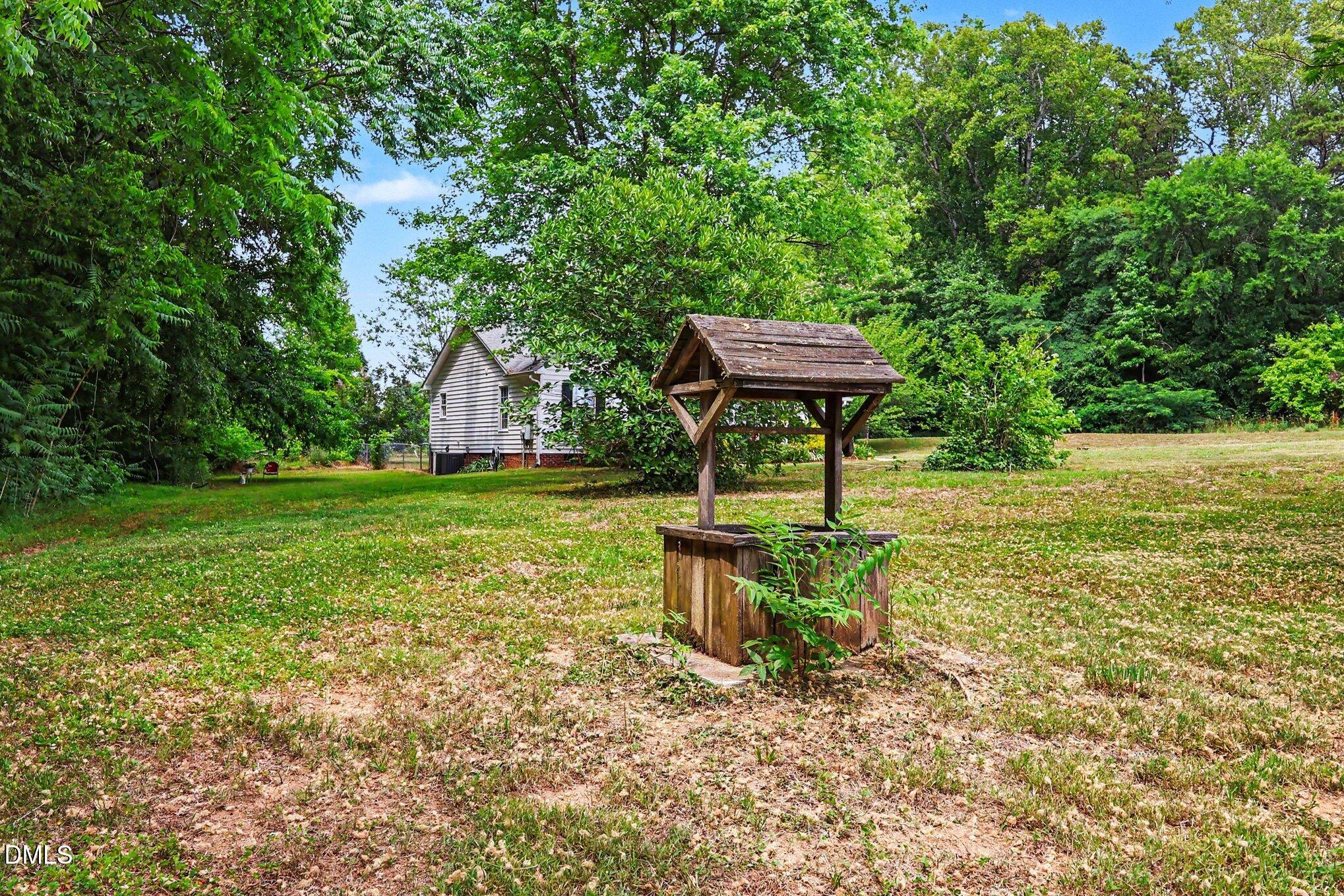 1750 Tom Oakley Road Timberlake, NC 27583 - Photo 27 of 31 a view of a garden with a bench