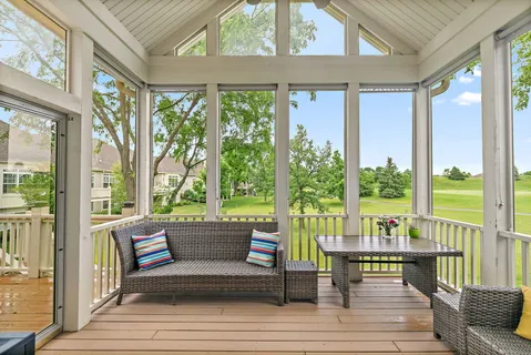 a living room with large windows and wooden floor