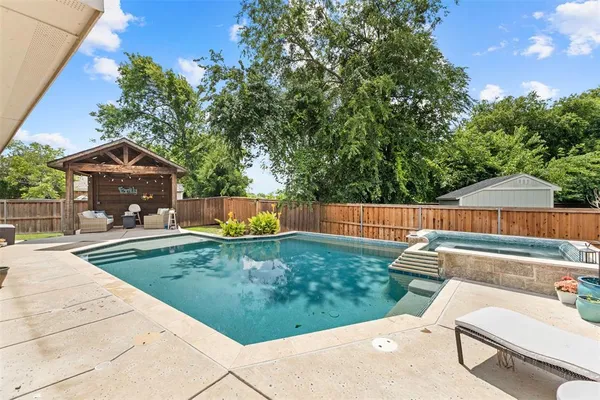 a view of a backyard with sitting area