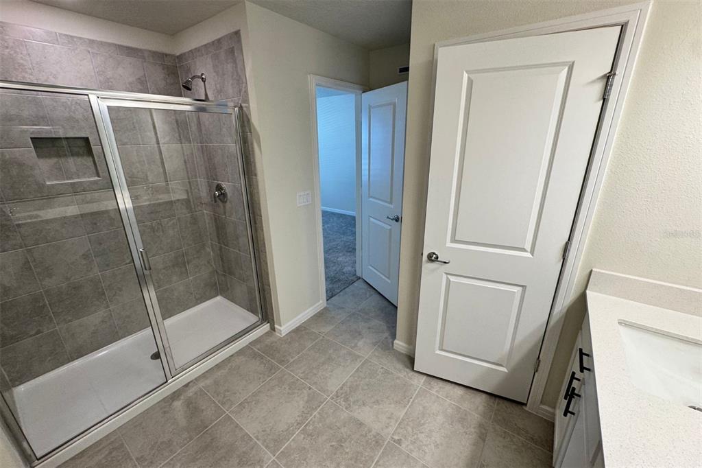 2759 Fetching Trail Davenport, FL 33896 - Photo 11 of 14 a bathroom with a shower and a glass door