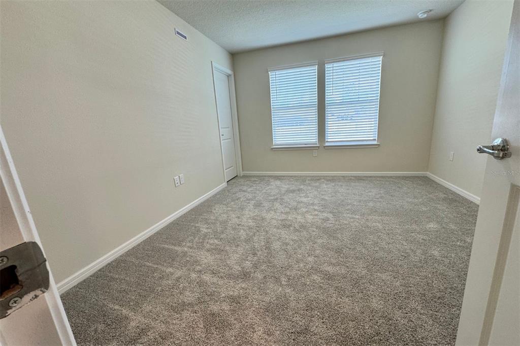 2759 Fetching Trail Davenport, FL 33896 - Photo 12 of 14 an empty room with windows
