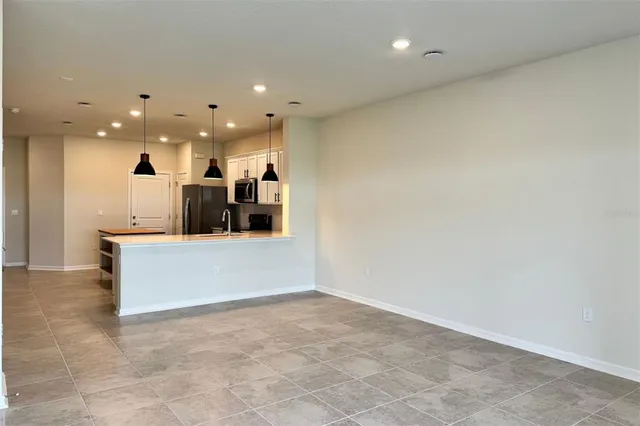 a kitchen with a stove and a chandelier