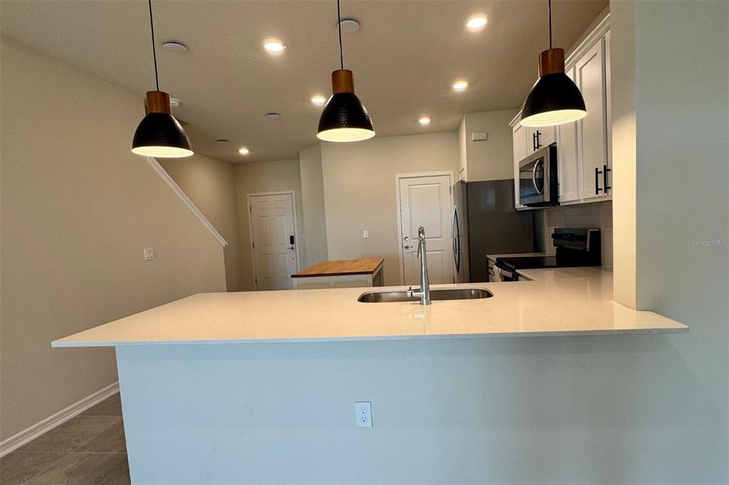 2759 Fetching Trail Davenport, FL 33896 - Photo 6 of 14 a kitchen with a stove and a chandelier