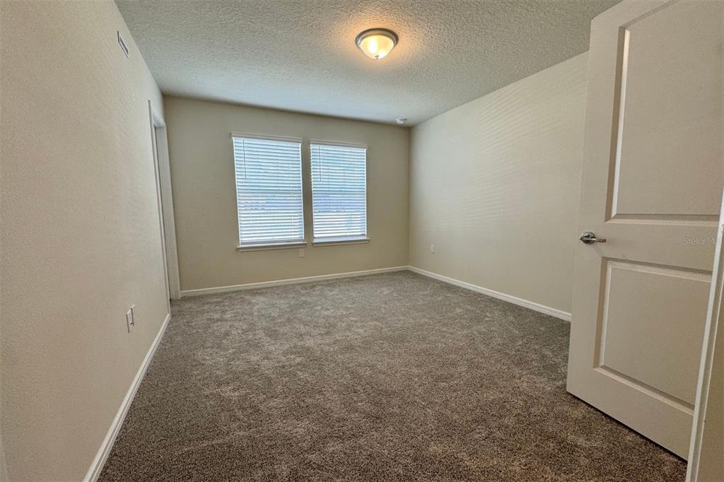 2759 Fetching Trail Davenport, FL 33896 - Photo 9 of 14 an empty room with a empty space and windows