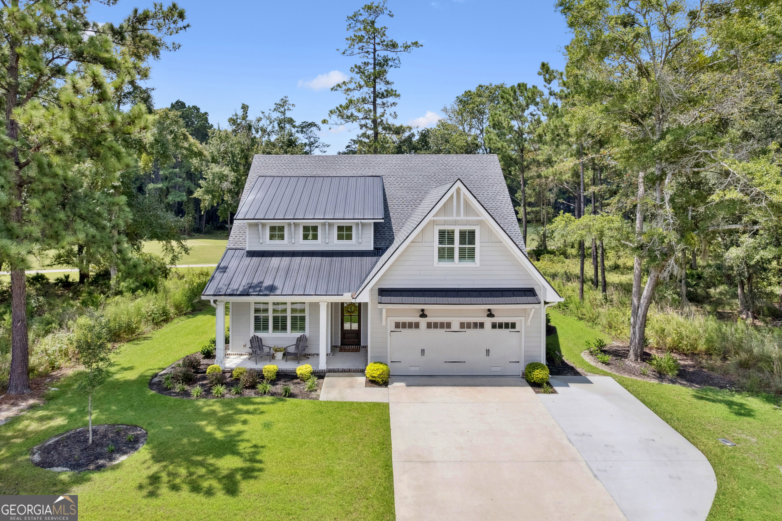 a front view of house with yard and green space