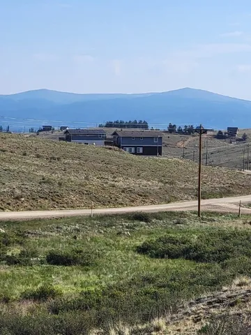 a view of a field with an ocean view