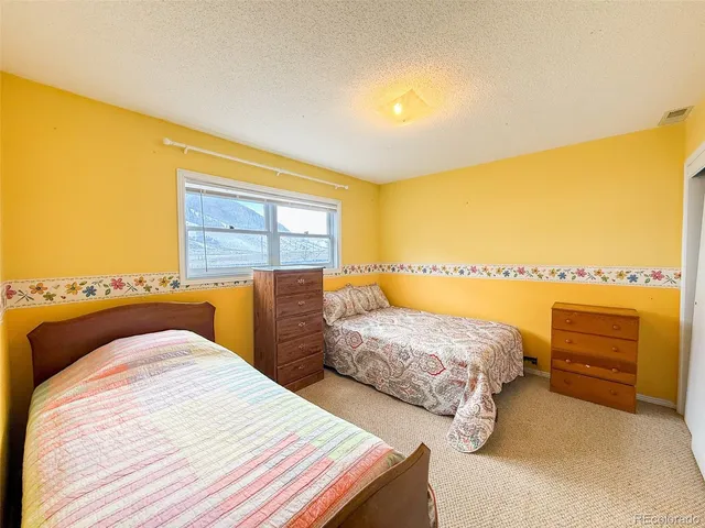 a bedroom with a bed and a night stand