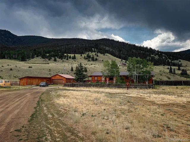 a view of a house with yard and lake view