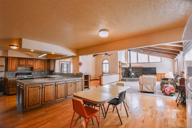a kitchen with stainless steel appliances granite countertop a stove and cabinets with wooden floor