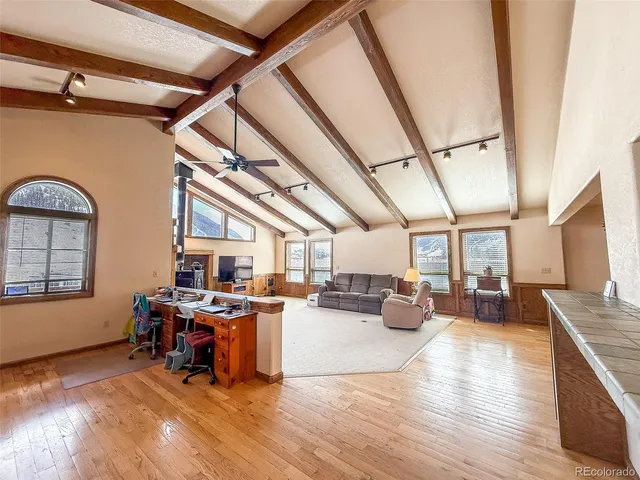 a living room with lots of furniture and white appliances