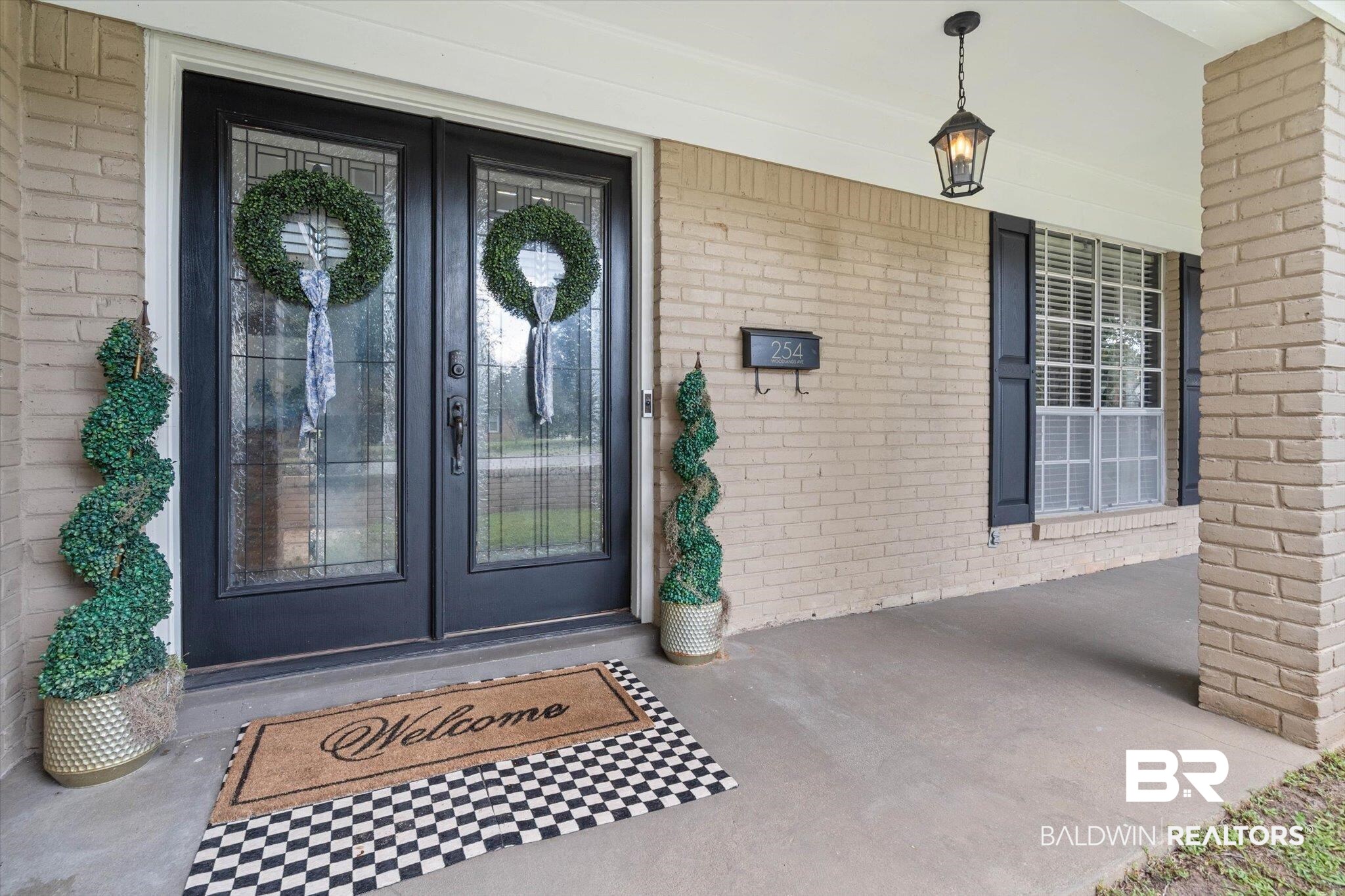 254 Woodlands Avenue Mobile, AL 36607 - Photo 3 of 50 Entrance to property featuring brick siding, a porch, and french doors