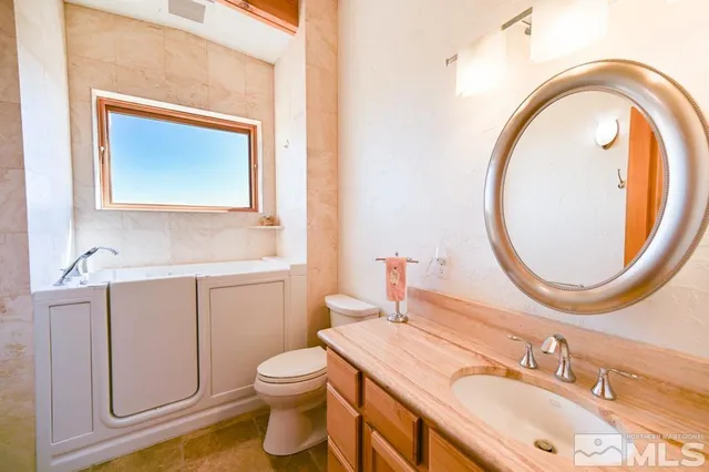 a bedroom with a bed and a refrigerator