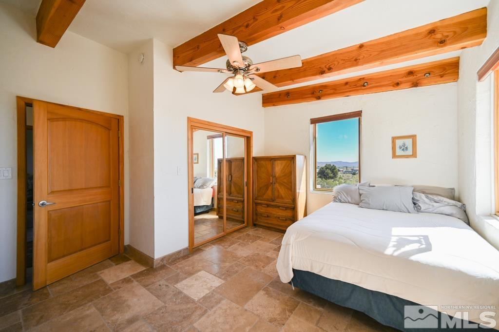 49 Pinon Drive Smith Valley, NV 89444 - Photo 18 of 45 a bedroom with a bed and a refrigerator