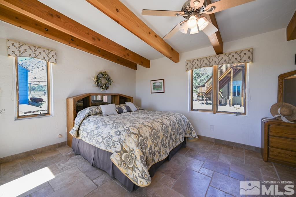 49 Pinon Drive Smith Valley, NV 89444 - Photo 29 of 45 a bedroom with a bed and a chandelier