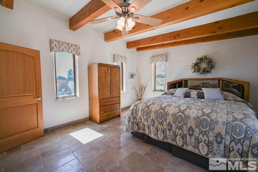 49 Pinon Drive Smith Valley, NV 89444 - Photo 30 of 45 a bedroom with a large bed and ceiling fan