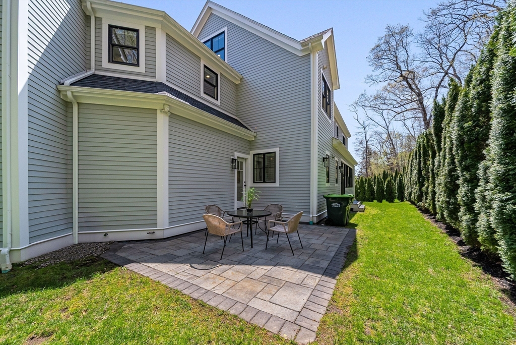 17 Sunrise Terrace Needham, MA 02492 - Photo 39 of 42 a backyard of a house with table and chairs