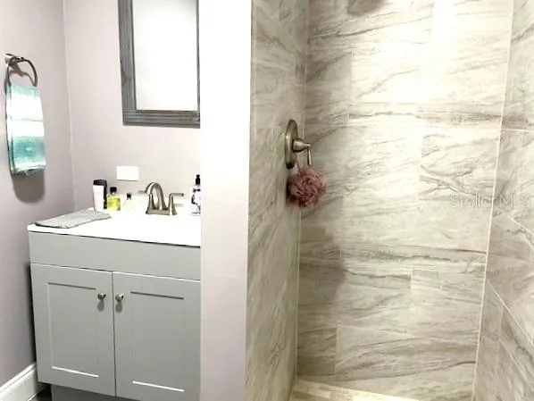 a bathroom with a shower and a sink