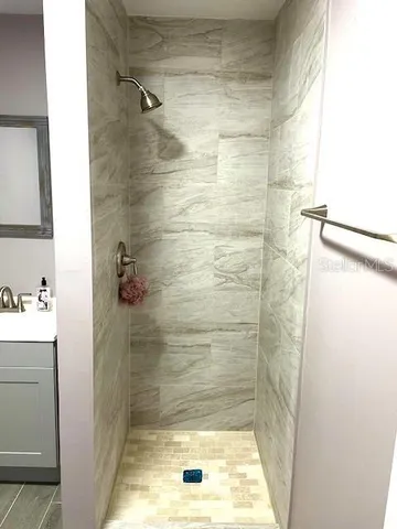 a view of a room with wooden floor and a window