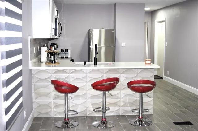 a kitchen with appliances a sink and a stove