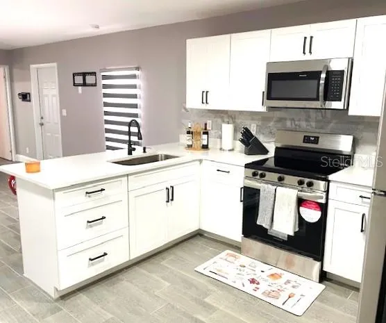 a kitchen with a stove and a microwave