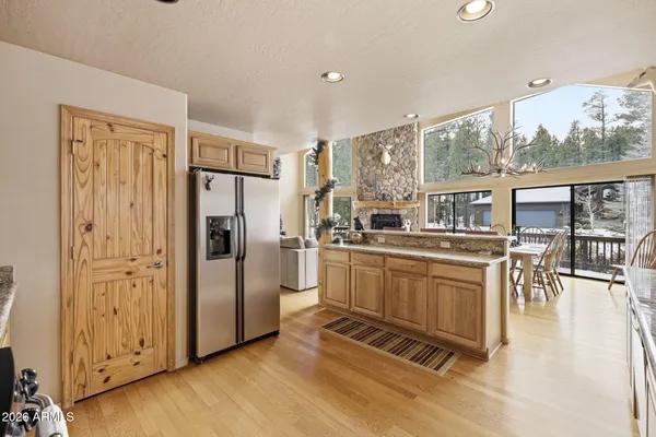 a dining room with furniture water view and a floor to ceiling window