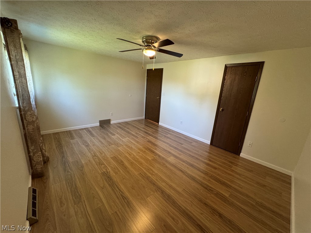 5221 E Cline Road Kent, OH 44240 - Photo 10 of 16 Spacious bedroom #1 with new Pergo flooring, ceiling fan and window. Has access to the full bathroom and a walk-in closet.