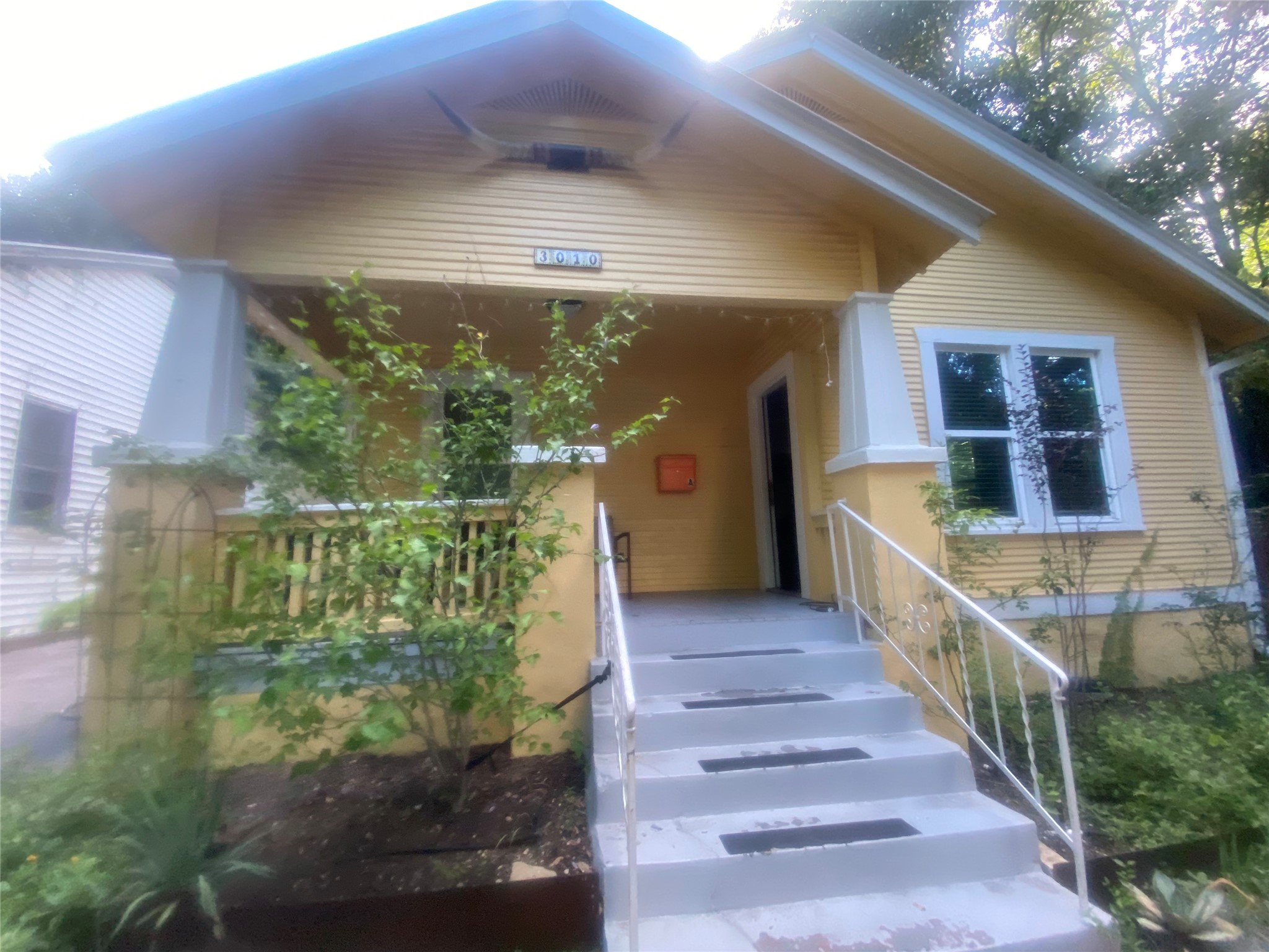 3010 Fruth Street, Unit A Austin, TX 78705 - Photo 1 of 39 A charming Craftsman bungalow presents a welcoming entry with a broad porch and mature landscaping.