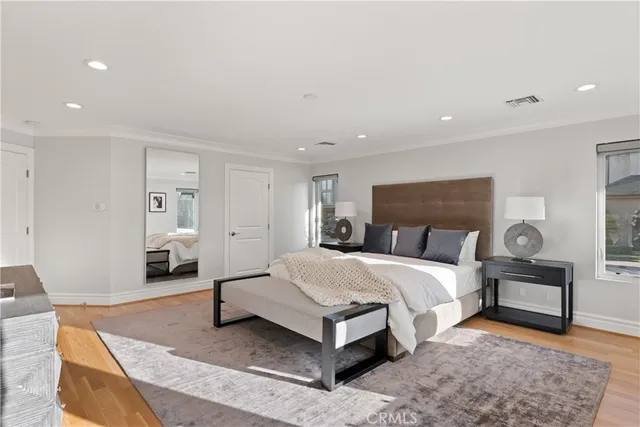 a patio with table and chairs and potted plants