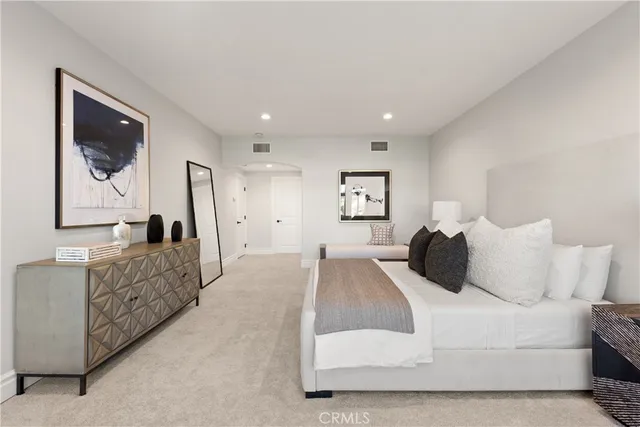 a bedroom with a bed and a couch