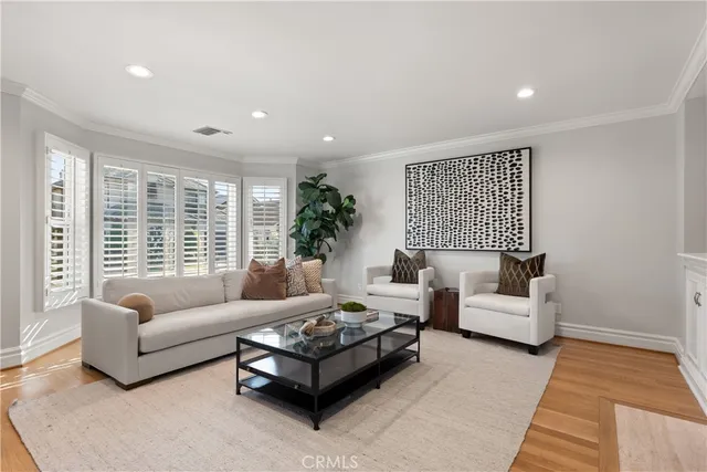 a living room with furniture a fireplace and kitchen view
