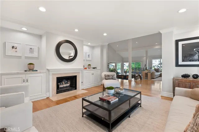 a living room with furniture a fireplace and a potted plant