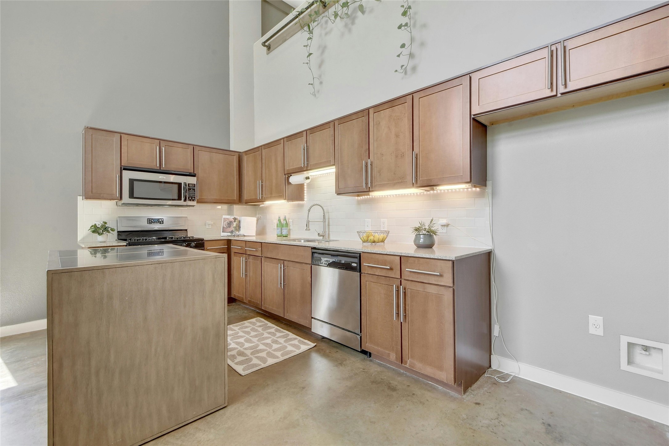1601 East Cesar Chavez Street, Unit 201 Austin, TX 78702 - Photo 12 of 30 a kitchen with granite countertop cabinets and steel stainless steel appliances