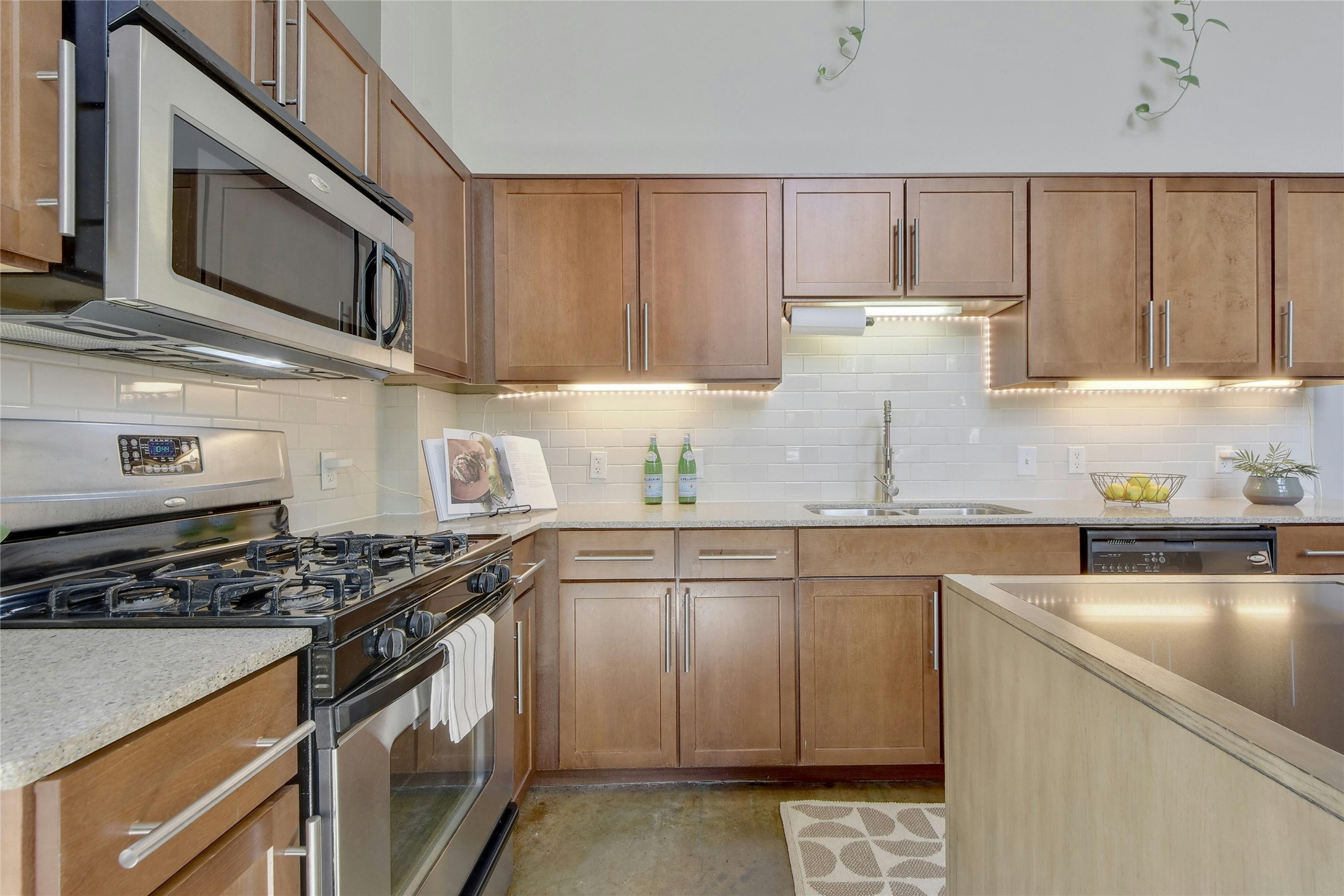 1601 East Cesar Chavez Street, Unit 201 Austin, TX 78702 - Photo 15 of 30 a kitchen with granite countertop cabinets stainless steel appliances and a sink