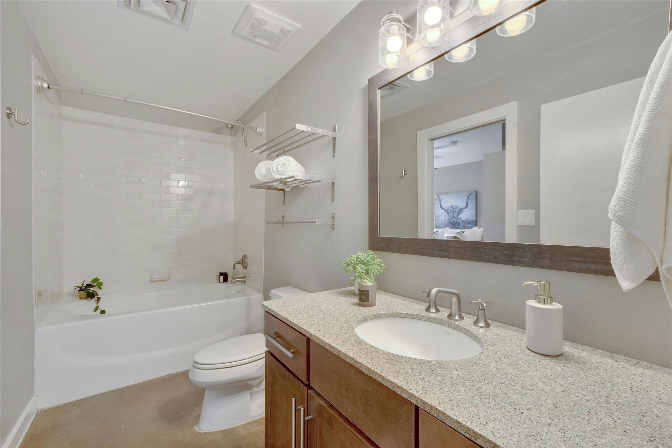 1601 East Cesar Chavez Street, Unit 201 Austin, TX 78702 - Photo 22 of 30 a bathroom with a granite countertop sink a toilet a mirror and shower