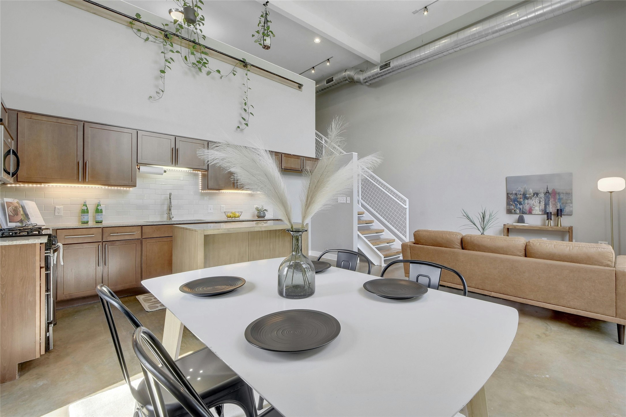 1601 East Cesar Chavez Street, Unit 201 Austin, TX 78702 - Photo 7 of 30 a kitchen with a table chairs and a stove