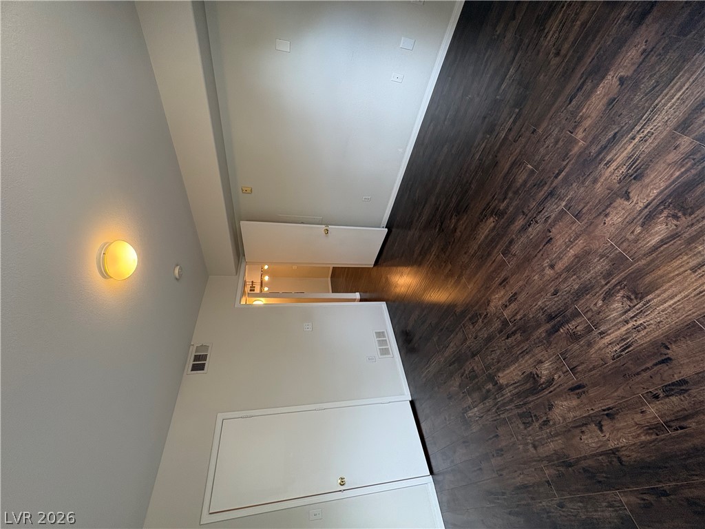 7255 West Sunset Road, Unit 2023 Las Vegas, NV 89113 - Photo 18 of 24 Rich dark wood flooring anchors this versatile interior space with clean architectural lines.