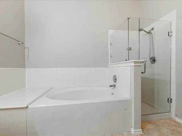 a bathroom with a bathtub and a shower